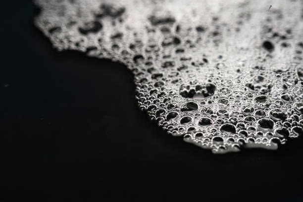 istock Foam texture. Soap foam with bubbles. Foam on a dark 2177988320