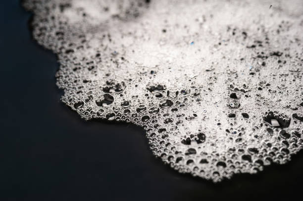 istock Foam texture. Soap suds with bubbles. Foam on a wet dark 2177988326