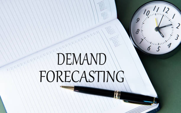 istock DEMAND FORECASTING - words in a white notebook on a dark green background with a clock 2177988913