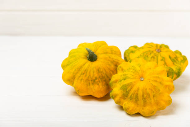 Yellow pumpkin on a gray warm blanket and table, place for text