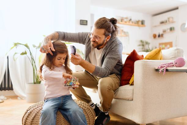 istock Loving father brushing his daughters hair 2177989902