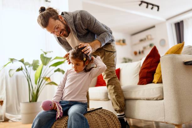 istock Father making a hairstyle for his daughter 2177989929