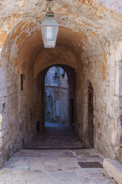 istock Narrow stone alleyway with arched passage and lantern in Dubrovnik 2177992635