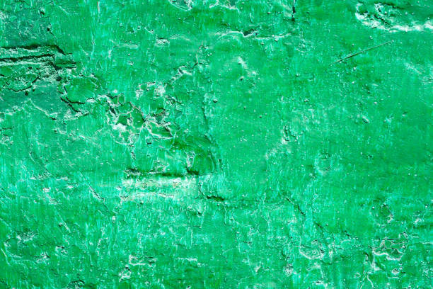 istock Plaster texture. Peeling green paint on a plastered wall 2177994327