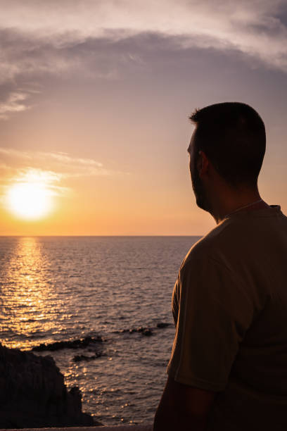 istock Unrecognizable young man in a beautiful sunset in Mykonos 2177994826