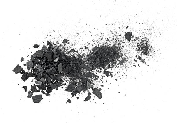 istock Black charcoal particles isolated on a white background, top view. Black dust powder charcoal. 2177995305