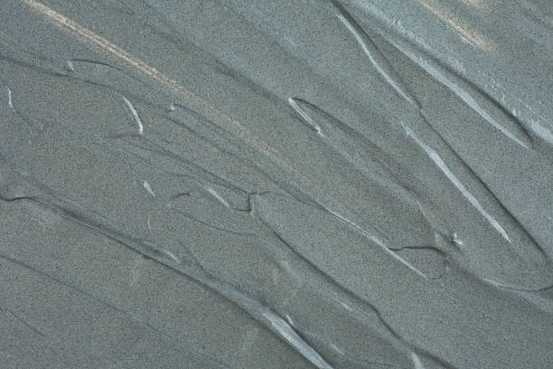 istock Grey cosmetic clay texture, top view. Abstract background with brush strokes. Mud mask for face and body. 2177995310