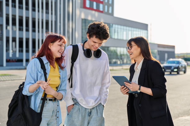 istock Woman agent teacher social worker working with college students using digital tablet outdoor 2177997072