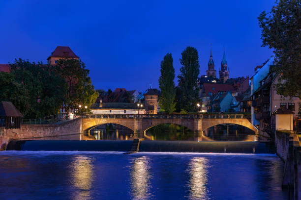 The ancientstone Max Bridge in the old town, viewed from Kettensteg at night, Nueremberg, Germany