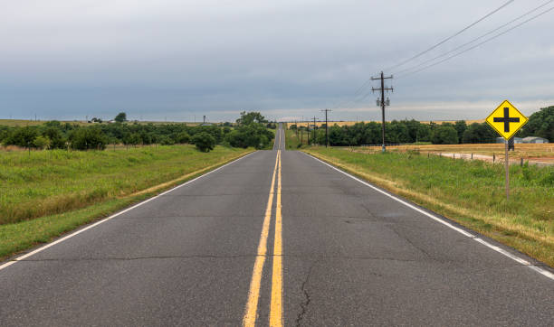 istock Journey through rural Oklahoma heartland. Two lane highway cuts through grassy fields under overcast skies 2177998058