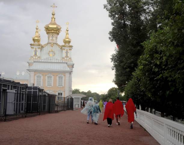 rainy weather in St. Petersburg.\nPeterhof. Saint Petersburg . Russia. July 20, 2024.\nRain. Lower garden in Petrodvorets park. People in raincoats walk through the park (usual weather in St. Petersburg)