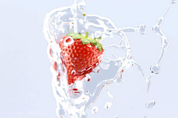 Fresh Fruit, Red Strawberries Tossed in Water, White Background