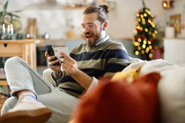 istock Man doing Christmas shopping on his smartphone 2178000073