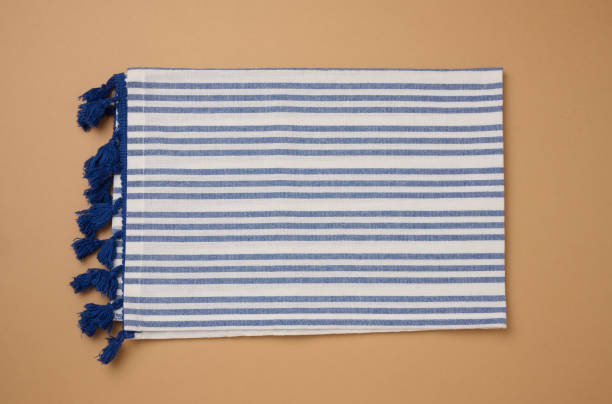 istock Folded linen striped kitchen towel on brown background, top view 2178001955