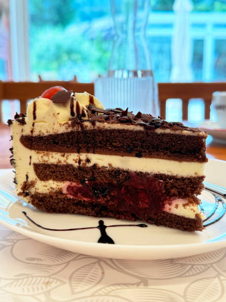istock Delicious layered chocolate cake slice with cream and berries 2178002859