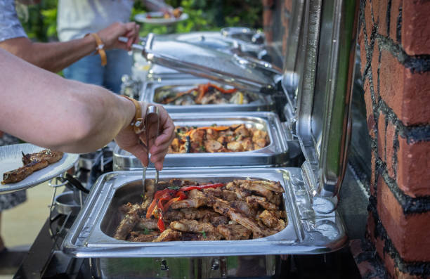 istock Guests order food from the self-service barbecue buffet 2178003832