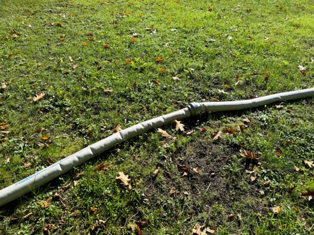 istock Flexible water pipe lying on grassy lawn 2178004599