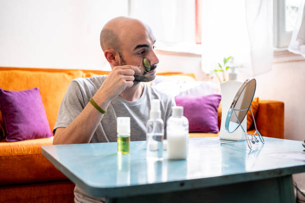 istock Young man applying beauty product at home 2178005455