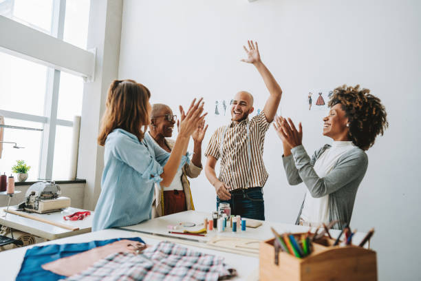 istock Group of people in sewing studio celebrate success 2178006523
