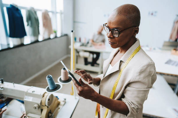 Portrait of a seamstress using a digital tablet