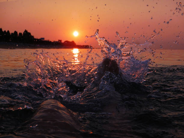 feet splashing in the sea at dawn