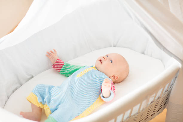 istock Cute baby boy in a white crib 2178008539