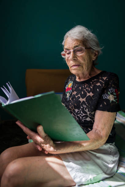 istock Elderly Woman Reading a Book in Natural Light 2178010177