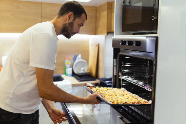 istock Putting freshly homemade pizza into oven 2178014296