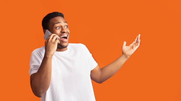 istock Surprised black guy talking on the phone and gesturing 2178014300