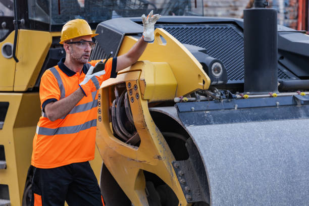 istock Construction worker directing heavy machinery during roadwork in an urban area on a sunny day 2178014860