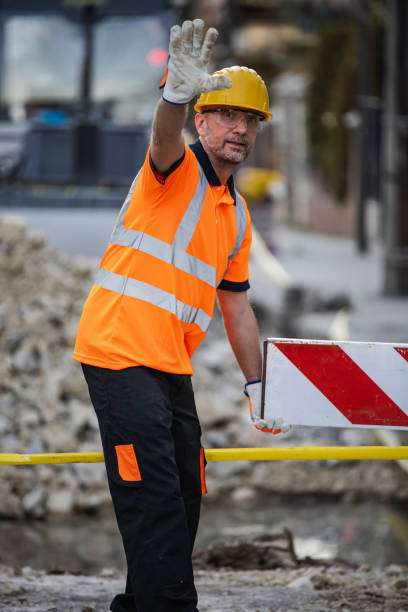 istock Construction worker directing traffic near roadwork site with safety gear in the late afternoon 2178014916