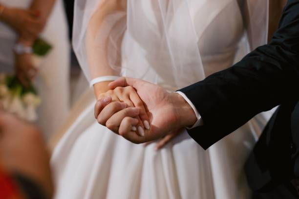 istock Bride and groom holding hands at wedding 2178015202