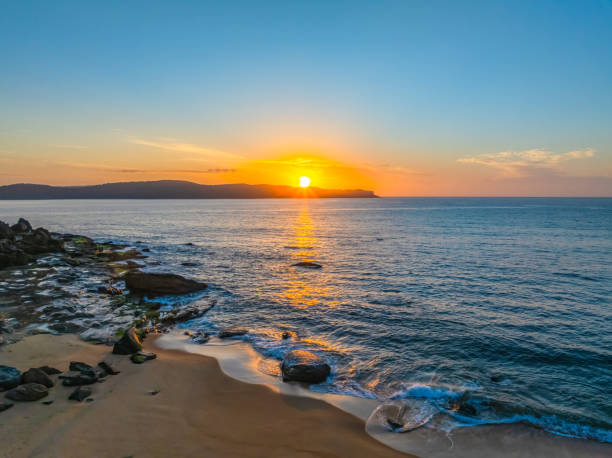 istock Aerial sunrise at the seaside with light scattered high cloud and a low cloud bank 2178016494