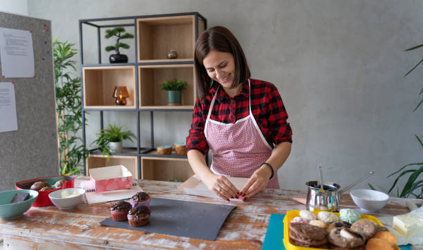 istock Woman Enjoying Baking and Decorating Cupcakes at Home 2178016775