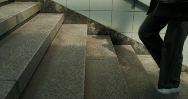 istock A woman walks up the stairs 2178019577