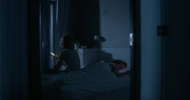 istock A man and a woman use mobile phones in bed 2178019876