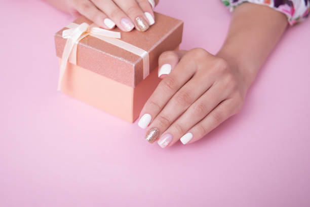 istock Female hands with romantic manicure nails, white gel polish 2178021099