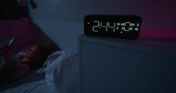 istock A woman uses a mobile phone at night 2178021429