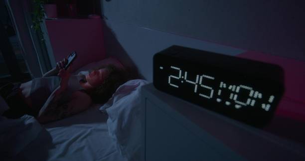 istock A woman uses a mobile phone at night 2178021437