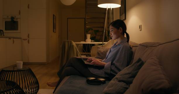 istock A woman with a laptop at home 2178022196