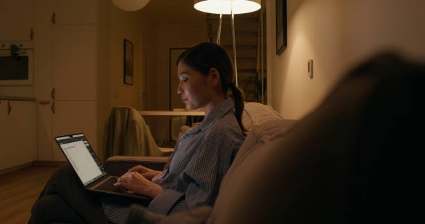 istock A woman with a laptop at home 2178022245