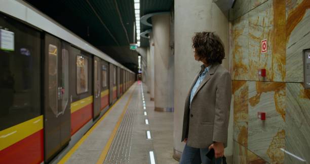 istock A woman stands on a subway platform 2178022267