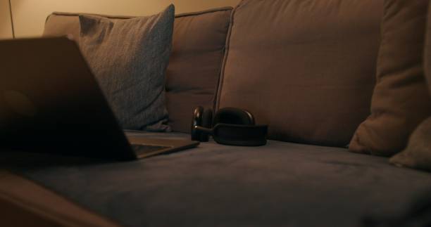 istock Laptop and headphones on the couch 2178022312