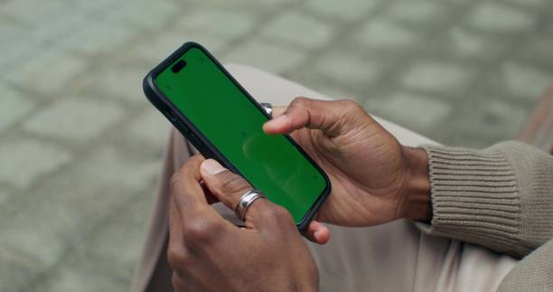 istock A man uses a mobile phone sitting outdoors 2178022526
