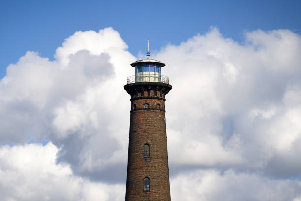 historic helios lighthouse in cologne ehrenfeld in front of a blue sky with cumulus clouds