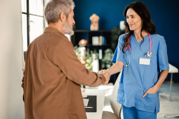 istock Doctor kindly welcoming a patient 2178025599