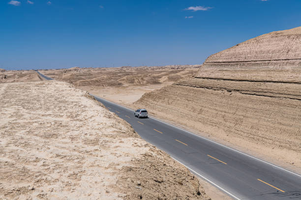 The highway going through Yadan geoform in Qinghai, China. Copy space for text