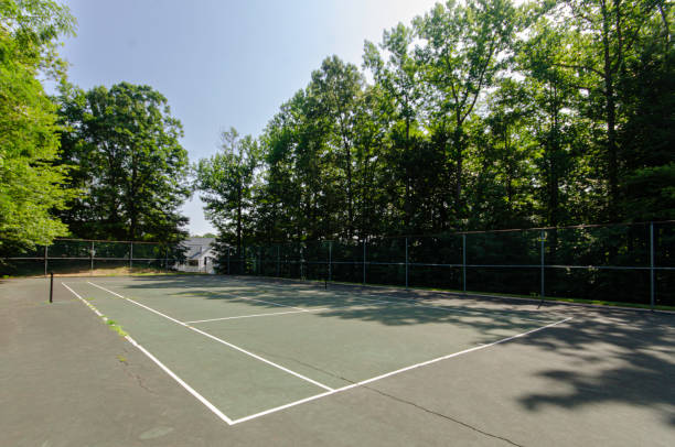 istock Empty Tennis Court Surrounded By Lush Green Trees. 2178028867