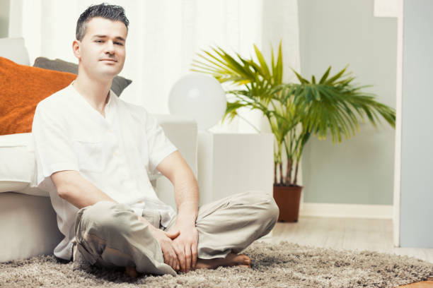istock Man relaxing at home sitting on the floor 2178035875