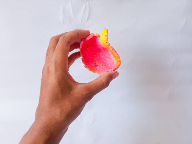 istock Asian female hand holding crispy pink crackers and isolate on white. 2178037487